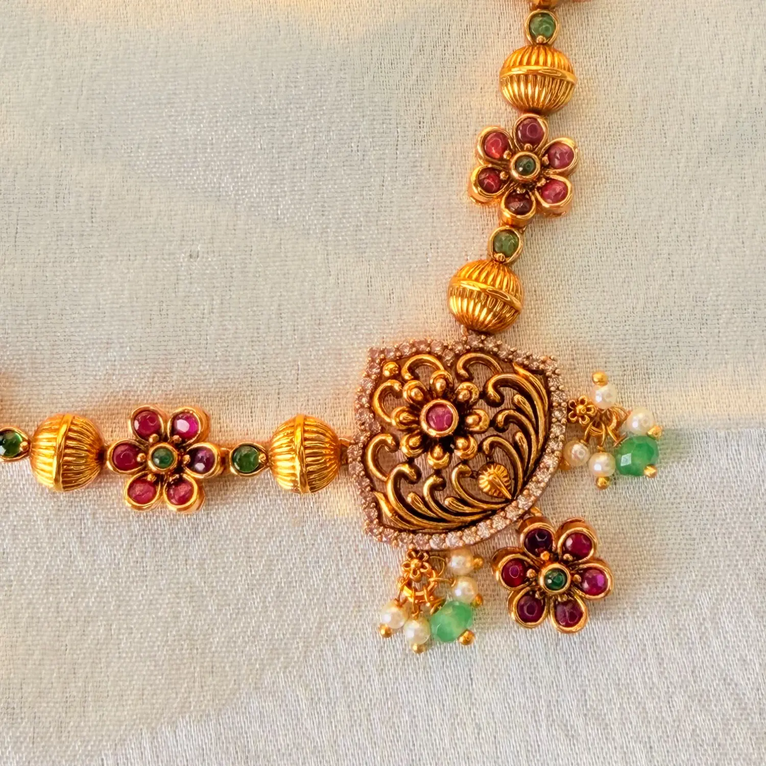 Traditional Gold-Plated Floral Temple Necklace Set with Ruby and Emerald Accents and Matching Earrings SJPM030