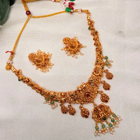 Antique Matte Gold Goddess Lakshmi & Mayuri Nakshi Neckpiece with Hanging Kemp Leaf Charms, Green Beads & Matching Pearl Jhumkas SJSN075