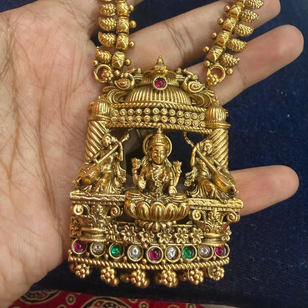 Gold Replica Antique Matte Manga Mala (Mango Haram) with Architectural Temple Mantap Pendant featuring Seated Lakshmi & Veena Musicians, paired with Temple Jhumkas