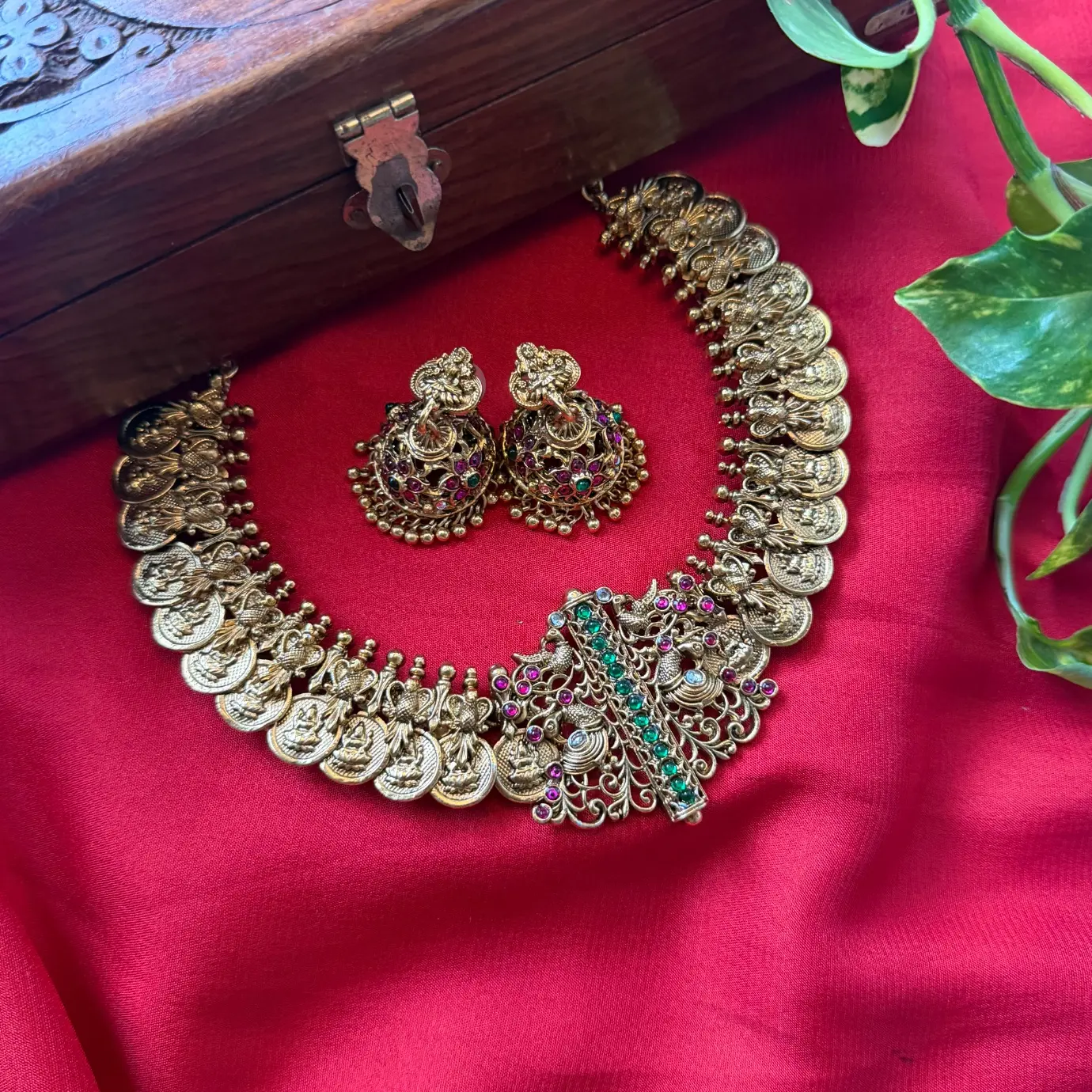 Gold Replica Antique Matte Charvi Kasu Mala (Lakshmi Coin Necklace) with Asymmetrical Filigree Peacock Side Brooch, Emerald-Ruby Kemp Bar & Kemp Jhumkas