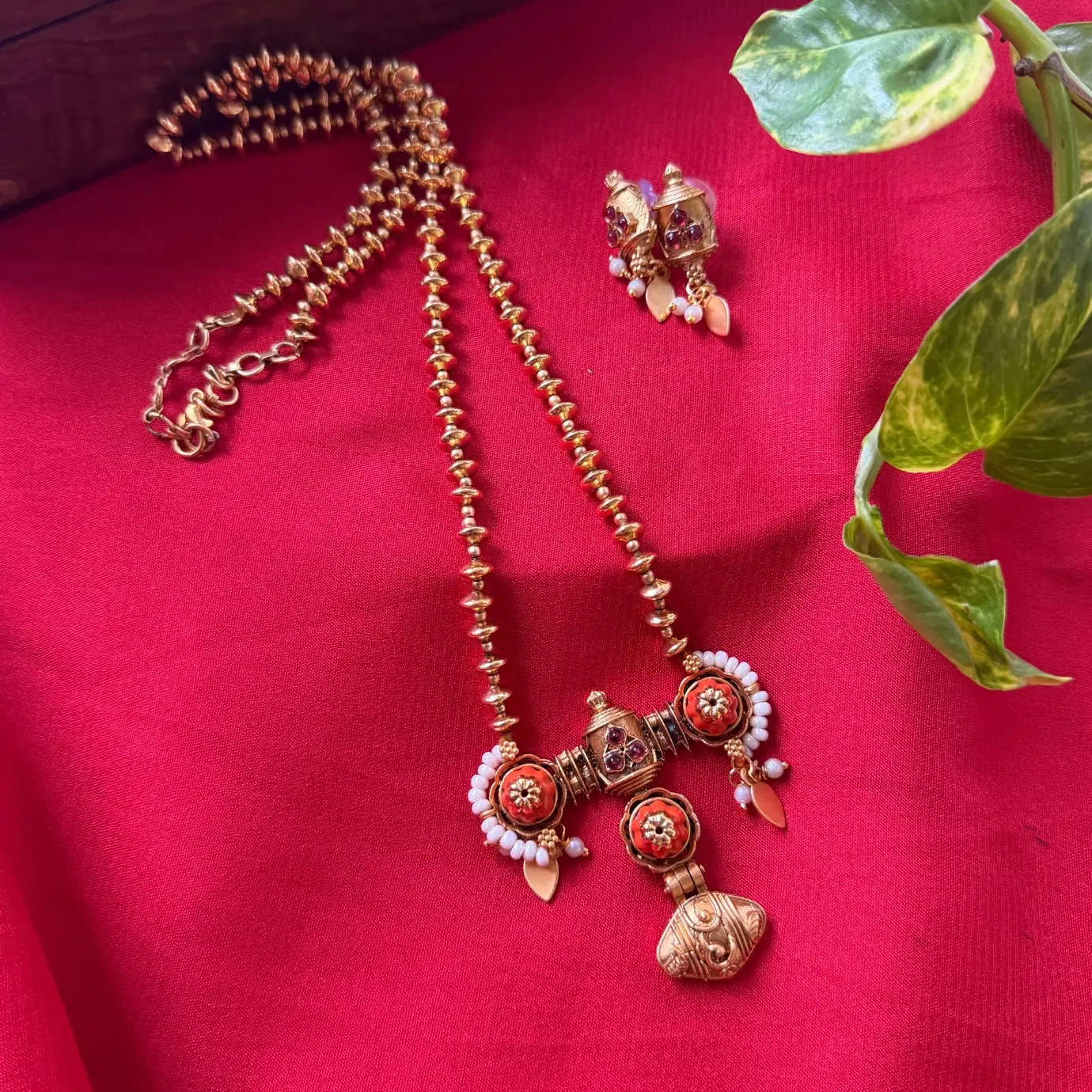 Gold Replica Antique Matte Beaded Long Chain Mala with Architectural Coral-Ruby Floral Pendant & Matching Pearl-Accented Drop Earrings