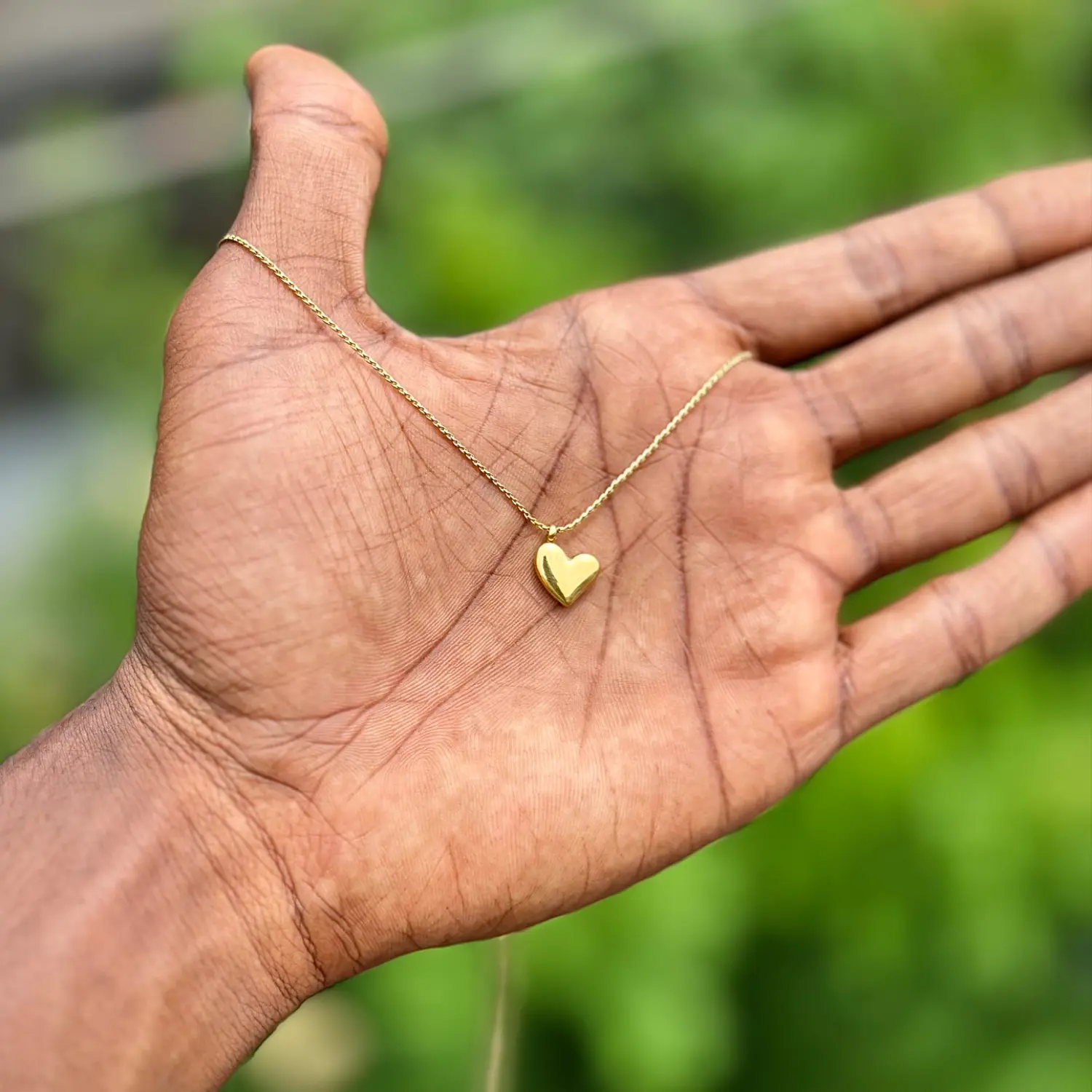 Minimalist gold puffy heart pendant necklace.